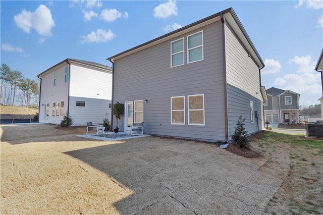 back of property with entry steps, a patio, and cooling unit