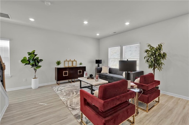 living area featuring light wood-type flooring, baseboards, visible vents, and recessed lighting