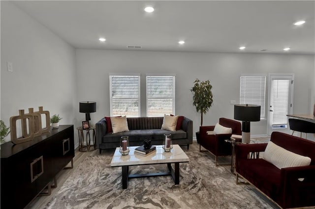 living area featuring recessed lighting, visible vents, and light wood finished floors