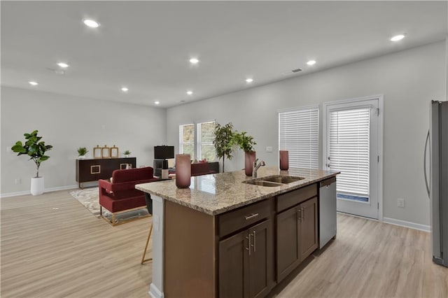 kitchen with appliances with stainless steel finishes, recessed lighting, light wood-style floors, and a sink