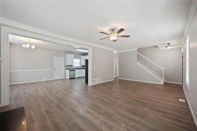274 Sleepy Hollow Rd, Powder Springs, GA 30127 - unfurnished living room featuring crown molding, stairway, baseboards, ceiling fan with notable chandelier, and dark wood-style flooring