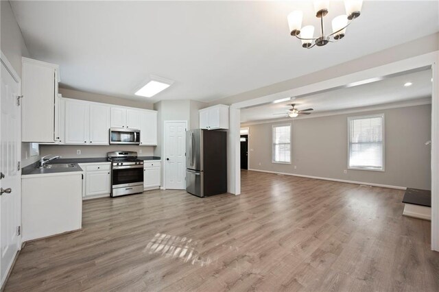 274 Sleepy Hollow Rd, Powder Springs, GA 30127 - kitchen with open floor plan, white cabinetry, stainless steel appliances, baseboards, and light wood-style flooring