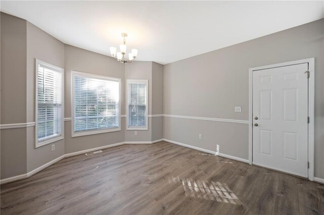 274 Sleepy Hollow Rd, Powder Springs, GA 30127 - empty room with baseboards, wood finished floors, and a chandelier