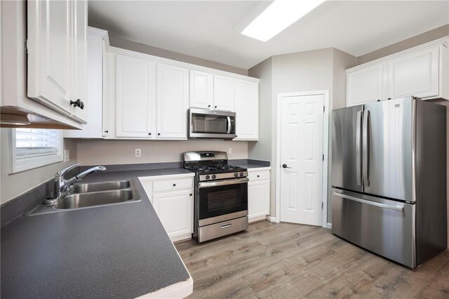 274 Sleepy Hollow Rd, Powder Springs, GA 30127 - kitchen featuring white cabinets, a sink, stainless steel appliances, and light wood-style flooring
