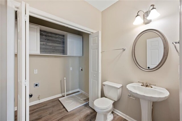 274 Sleepy Hollow Rd, Powder Springs, GA 30127 - half bathroom with baseboards, toilet, and wood finished floors