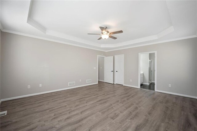 274 Sleepy Hollow Rd, Powder Springs, GA 30127 - unfurnished bedroom with baseboards, a tray ceiling, visible vents, and wood finished floors