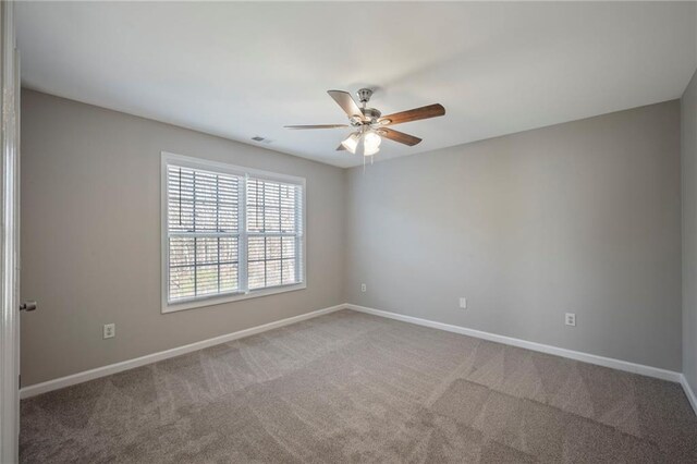 274 Sleepy Hollow Rd, Powder Springs, GA 30127 - carpeted empty room with baseboards, visible vents, and a ceiling fan