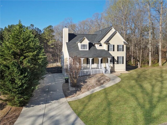 274 Sleepy Hollow Rd, Powder Springs, GA 30127 - view of front of home featuring a chimney, a front yard, covered porch, and roof with shingles