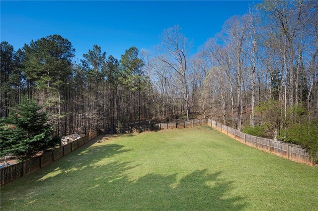 274 Sleepy Hollow Rd, Powder Springs, GA 30127 - view of yard with a fenced backyard and a view of trees