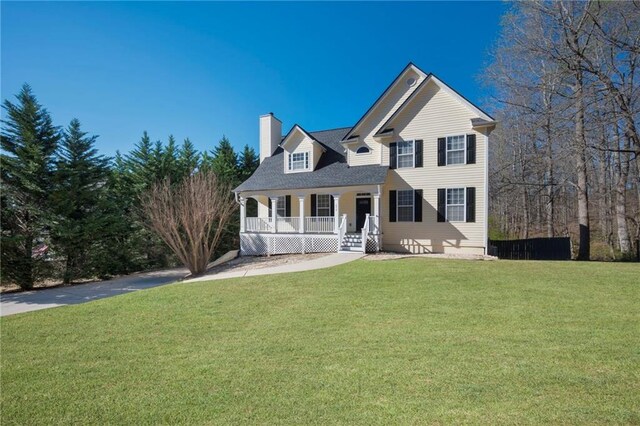 274 Sleepy Hollow Rd, Powder Springs, GA 30127 - traditional home featuring covered porch, a chimney, and a front yard