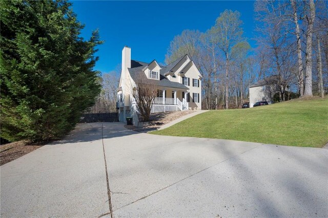 274 Sleepy Hollow Rd, Powder Springs, GA 30127 - view of side of home featuring a lawn, a chimney, a porch, and driveway