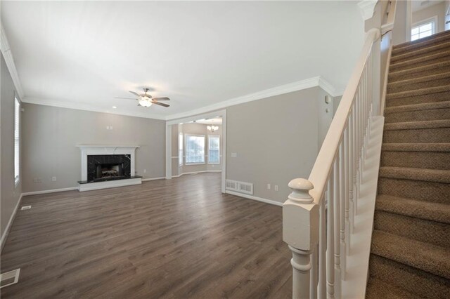 274 Sleepy Hollow Rd, Powder Springs, GA 30127 - unfurnished living room featuring dark wood-style flooring, visible vents, crown molding, baseboards, and a ceiling fan