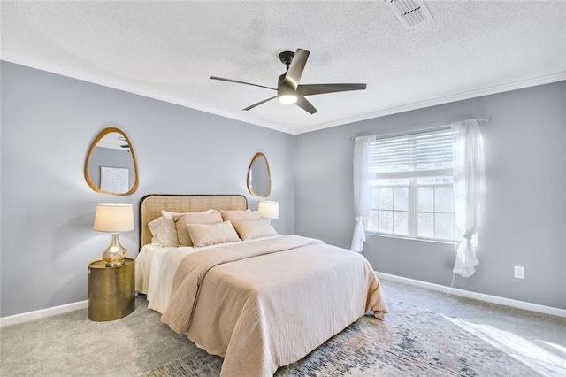 carpeted bedroom with ceiling fan, ornamental molding, and a textured ceiling