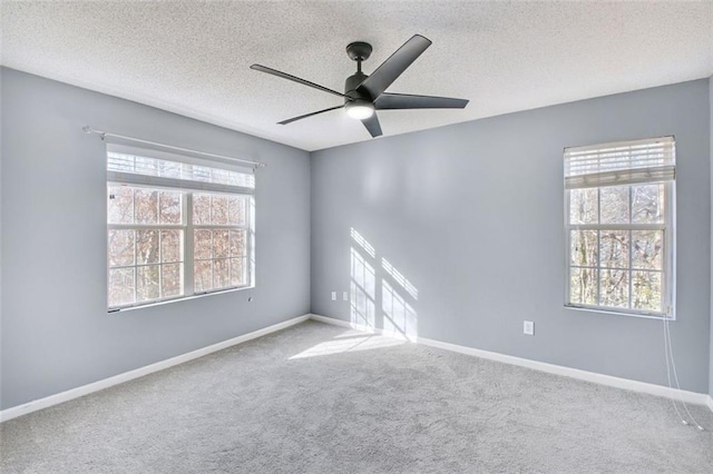 unfurnished room featuring carpet, a textured ceiling, and ceiling fan