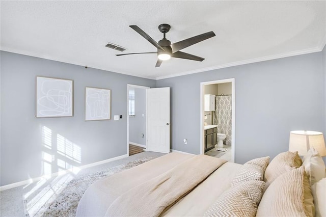 bedroom with ceiling fan, ensuite bathroom, and ornamental molding