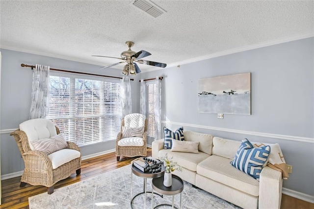 living room with dark wood-type flooring, a textured ceiling, and a wealth of natural light