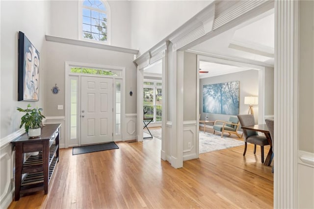 6795 Preston Glen Dr, Alpharetta, GA 30005 - entryway with light wood-style flooring, a wainscoted wall, a decorative wall, a high ceiling, and crown molding