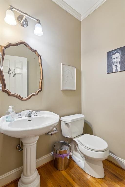 6795 Preston Glen Dr, Alpharetta, GA 30005 - bathroom with ornamental molding, wood finished floors, toilet, and baseboards