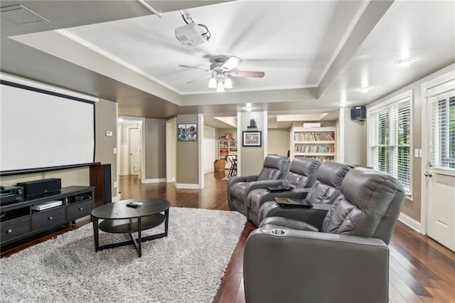 6795 Preston Glen Dr, Alpharetta, GA 30005 - cinema room featuring dark wood-style flooring, a ceiling fan, baseboards, ornamental molding, and a tray ceiling
