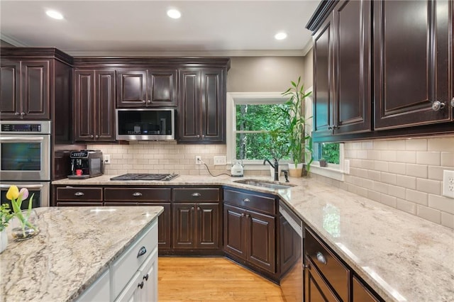 6795 Preston Glen Dr, Alpharetta, GA 30005 - kitchen with stainless steel appliances, a sink, ornamental molding, tasteful backsplash, and light stone counters