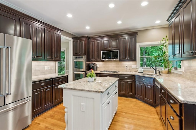 6795 Preston Glen Dr, Alpharetta, GA 30005 - kitchen featuring stainless steel appliances, a sink, ornamental molding, decorative backsplash, and plenty of natural light