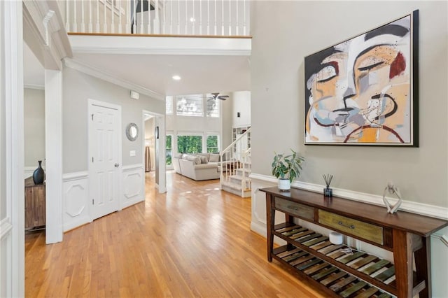 6795 Preston Glen Dr, Alpharetta, GA 30005 - foyer featuring ornamental molding, a towering ceiling, light wood-style flooring, and stairway