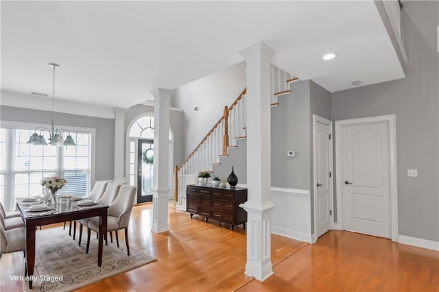 1027 Eagles Brooke Dr, Locust Grove, GA 30248 - entrance foyer featuring stairway, visible vents, light wood finished floors, and ornate columns