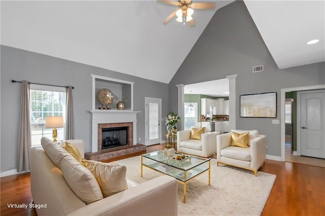 1027 Eagles Brooke Dr, Locust Grove, GA 30248 - living room featuring a fireplace, wood finished floors, high vaulted ceiling, and ceiling fan