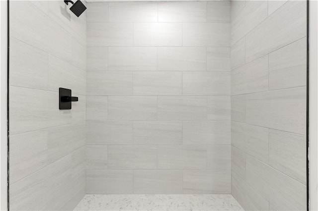 bathroom with tiled shower