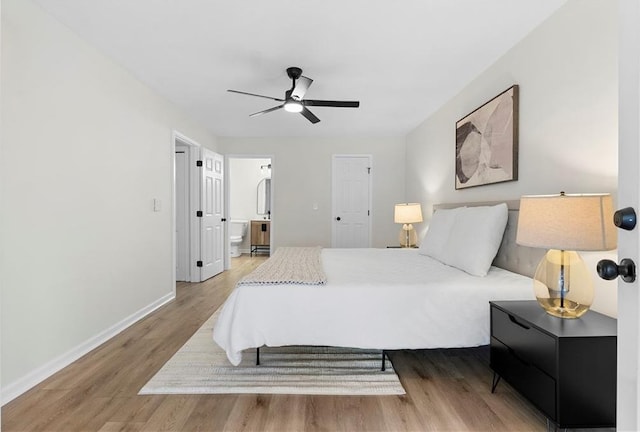 bedroom with ceiling fan, hardwood / wood-style floors, and ensuite bath