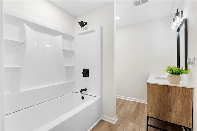 bathroom featuring  shower combination, wood-type flooring, and vanity