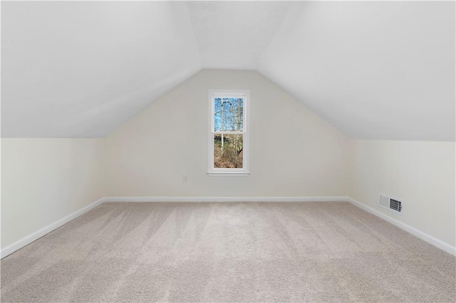 bonus room featuring lofted ceiling and carpet flooring