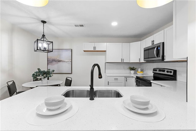 kitchen featuring sink, white cabinetry, backsplash, and black electric range oven