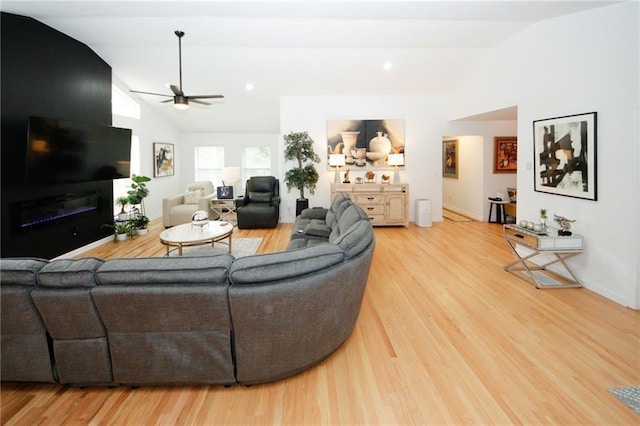 living room featuring lofted ceiling, ceiling fan, and light hardwood / wood-style floors