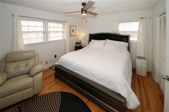 bedroom with a closet, ceiling fan, and wood-type flooring