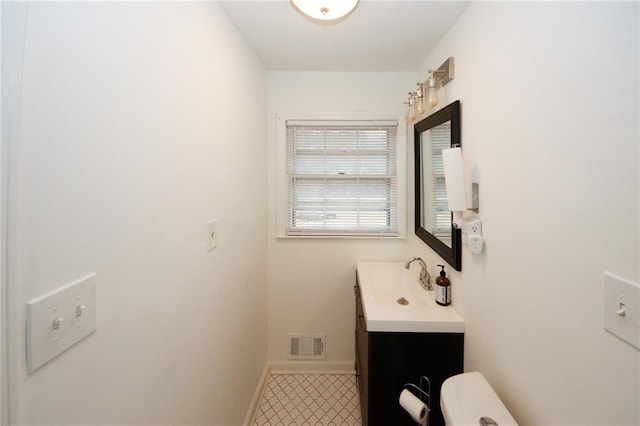 bathroom with toilet and vanity