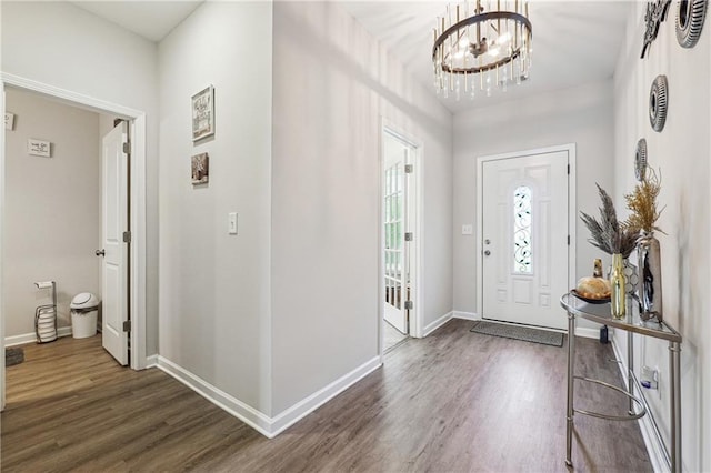 2646 Neighborhood Walk S, Villa Rica, GA 30180 - entrance foyer featuring an inviting chandelier, dark wood finished floors, and baseboards