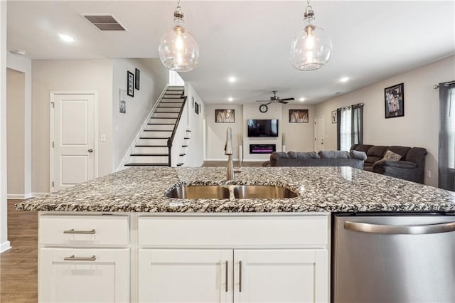 2646 Neighborhood Walk S, Villa Rica, GA 30180 - kitchen with a sink, stone countertops, visible vents, dishwasher, and open floor plan