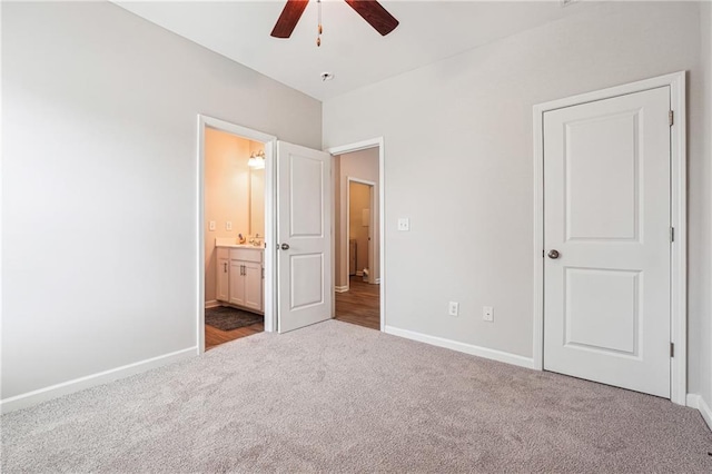 2646 Neighborhood Walk S, Villa Rica, GA 30180 - unfurnished bedroom with connected bathroom, baseboards, ceiling fan, and carpet floors
