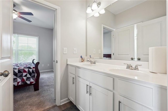 2646 Neighborhood Walk S, Villa Rica, GA 30180 - ensuite bathroom featuring double vanity, ensuite bath, ceiling fan with notable chandelier, and a sink