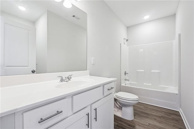 2646 Neighborhood Walk S, Villa Rica, GA 30180 - full bathroom with toilet, wood finished floors, vanity, visible vents, and washtub / shower combination