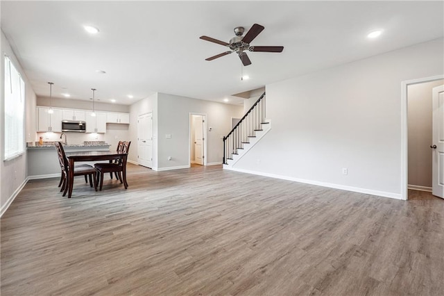 2646 Neighborhood Walk S, Villa Rica, GA 30180 - living area featuring recessed lighting, baseboards, ceiling fan, light wood-style floors, and stairway