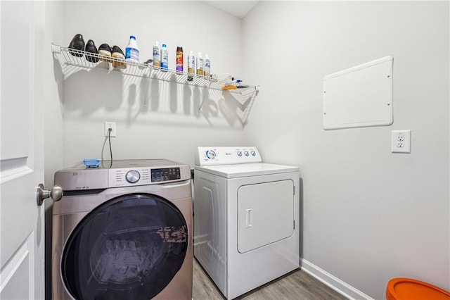 2646 Neighborhood Walk S, Villa Rica, GA 30180 - laundry room featuring baseboards, separate washer and dryer, laundry area, and light wood-style floors