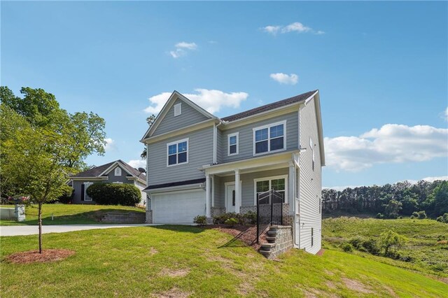 2646 Neighborhood Walk S, Villa Rica, GA 30180 - traditional home featuring a front lawn, a porch, an attached garage, and concrete driveway