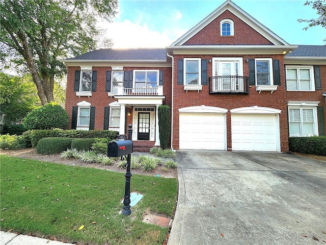 view of front of house with a balcony, a front lawn, and a garage