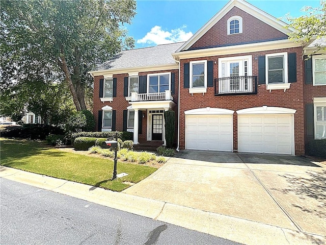 view of front of home with a balcony, a front lawn, and a garage