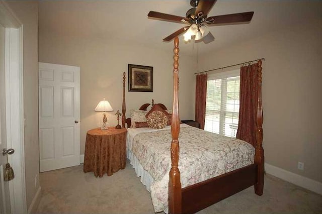 bedroom with ceiling fan, baseboards, and carpet floors