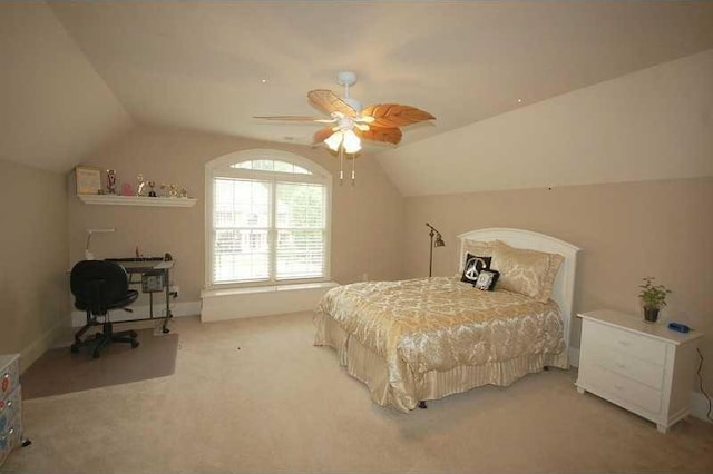 carpeted bedroom featuring a ceiling fan and vaulted ceiling