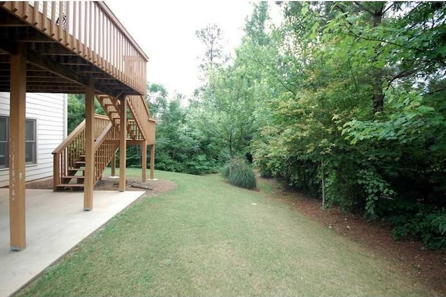 view of yard with a patio and stairs