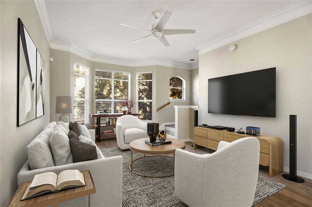 living room featuring hardwood / wood-style flooring, ceiling fan, and crown molding